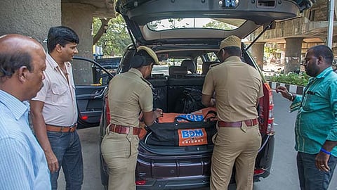 Flying squad team inspects a vehicle during a surprise check in Chennai