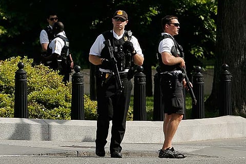 Secret Service agents stand guard near the White House  on Saturday