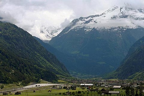 A view of the Swiss terrain and the tunnel through which trains will pass henceforth