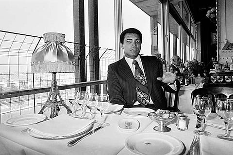 Muhammad Ali during lunch in the Eiffel Tower restaurant in Paris