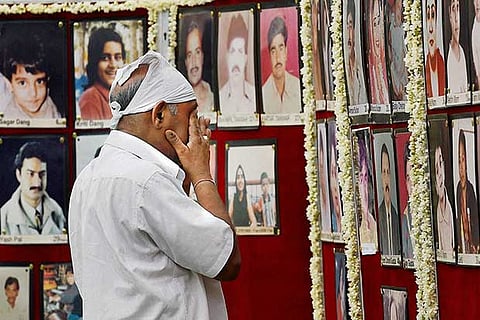 A man paying tribute to Uphaar tragedy victims on the 19th anniversary of the incident