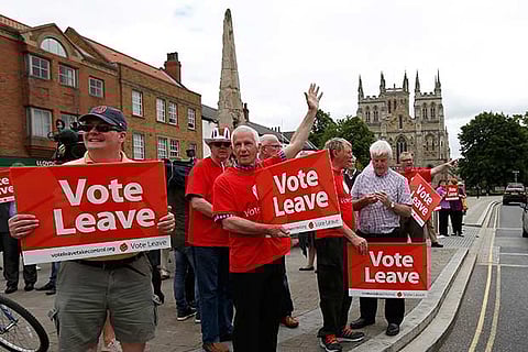 Supporters hold banners as former London Mayor Boris Johnson attends a "Vote Leave" rally in Britain