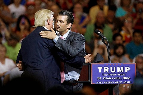 Republican presidential candidate Donald Trump, hugs his son Donald Trump Jr