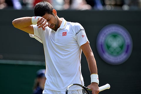 Novak Djokovic reacts after losing his Wimbledon third round match to Sam Querrey