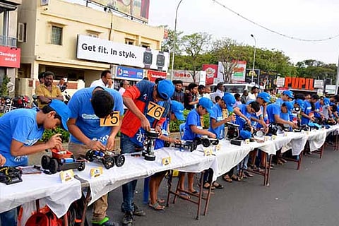 Students of robotics individually set up their machines from a kit at a rally at Elliot?s beach