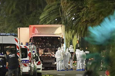 Officials inspect  the killer lorry at  Nice in France