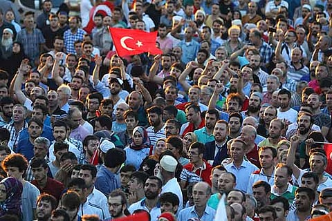 Supporters of Turkish President Tayyip Erdogan cheer at the Ataturk Airport in Istanbul, Turkey