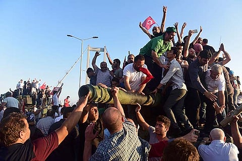 Supporters of President Tayyip Erdogan celebrate after soldiers involved in the coup surrender