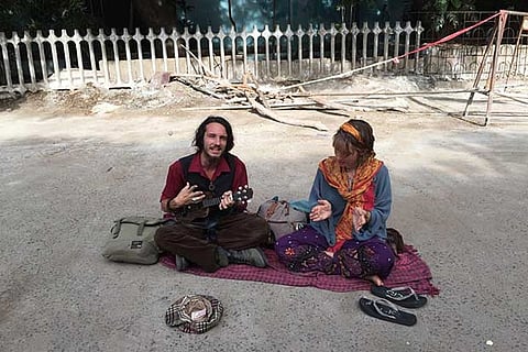 Shaun and Olene perform to collect money for travel