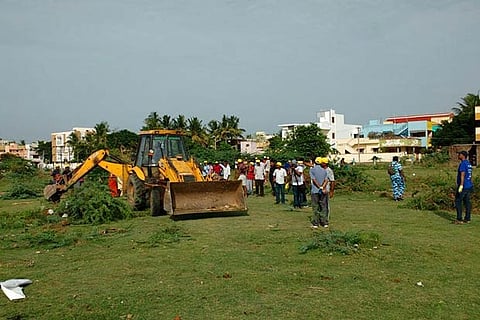 A file photo of residents supervising cleanup work near a housing colony in Chitlapakkam