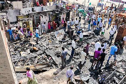Residents of Odai Kuppam near Besant Nagar inspect the remains of their huts on Wednesday morning