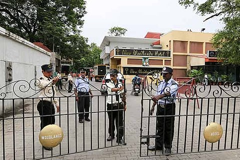 Private security personnel guarding the hotel premises after the attack by miscreants