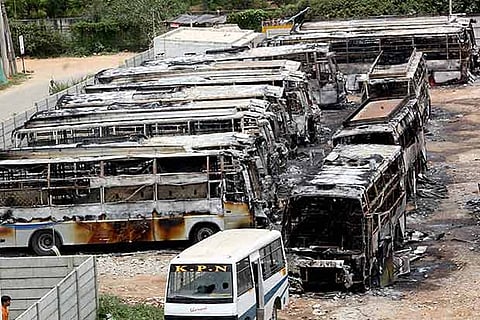 Charred remains of the buses of a private transport operator from Tamil Nadu in Bengaluru