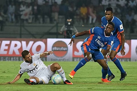 NorthEast United FC forward Emiliano Alfaro vies for the ball with FC Goa midfielder Goncalves