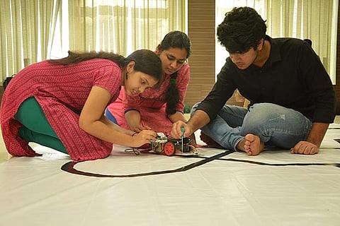 Students of Kaizen Robotics testing a robot in class