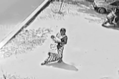 A screengrab of the woman walking away with the baby