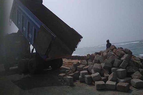 Boulders being unloaded by truck on the sides of the road at Dhanushkodi