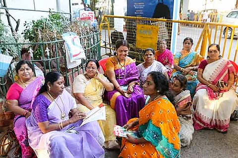 A group of AIADMK women sit near the main gate of Apollo Hospitals in Chennai