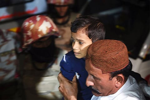 A man carries a boy injured after a bomb blast