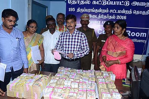 Collector, K.Veera Raghav Rao, inspecting the seized cash at Madurai