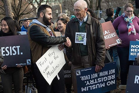 People march against a possible registration of Muslims in the US by the Trump administration