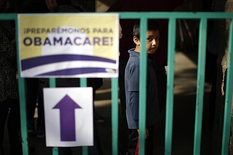 A file photo of a boy waiting in line at a health insurance enrollment event