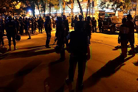 File picture of Bangladeshi personnel standing guard near the Holey Artisan Bakery