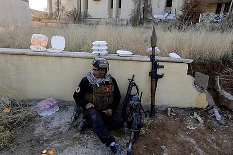 A member of Iraqi Special Operations Forces rests at the University of Mosul during a battle with IS