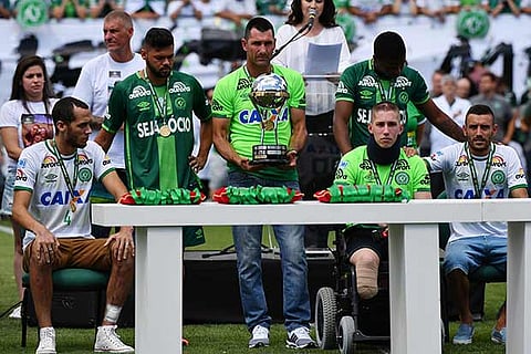 Survivers of the Chapecoense football team lift the Copa Sudamericana Trophy