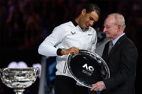Spain's Rafael Nadal receives his trophy from Rod Laver during the awards ceremony