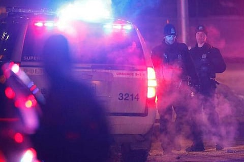 Police officers are seen near a mosque after a shooting in Quebec City