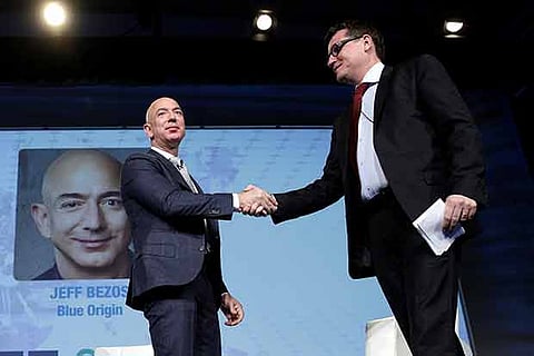 Jeff Bezos, founder, Blue Origin and CEO, Amazon, greets Rodolphe Belmer, CEO of Eutelsat