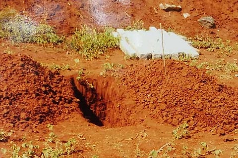 A pit dug by caste Hindus to bury a body at the farmland of a dalit in Tiruchy