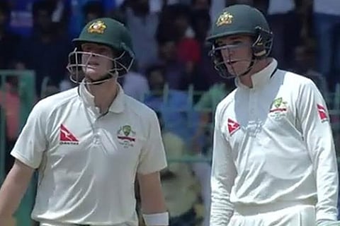 Steve Smith (left) and M Renshaw look towards the dressing room before taking a DRS call