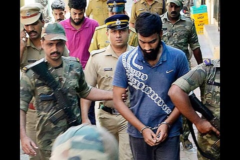 Kerala police and Armed Force personnel taking the accused to a house in Madurai