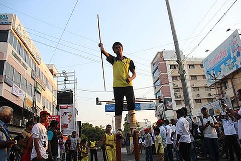 A youngster walking on stilts as part of the Happy Street  initiative