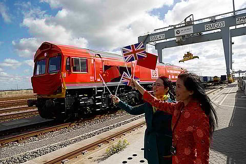 Women celebrate the first UK to China export train, laden with British goods, from London Gateway