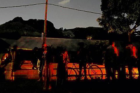 People gather on top of a bridge after a garbage dump collapse and bury over 100 houses (Reuters)