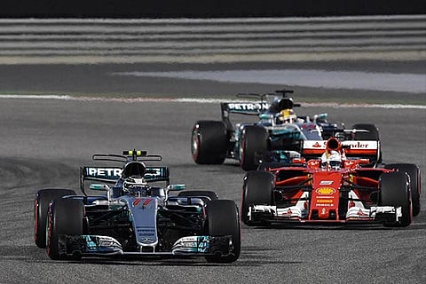 Valtteri Bottas (front), Sebastian Vettel (red car) and Lewis Hamilton during the Bahrain Grand Prix