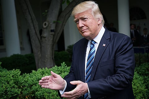 US President Donald Trump arrives in the Rose Garden of the White House