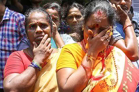 Grieving family members anxiously wait for fire and rescue personnel (Photo: Manivasagan N)