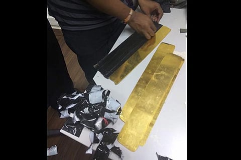 Revenue intelligence officials displaying the gold