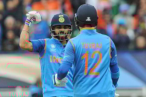 Virat Kohli congratulates Yuvraj Singh for scoring fifty runs during the match against Pakistan