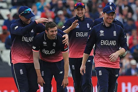 Mark Wood (second from left) celebrates with team mates