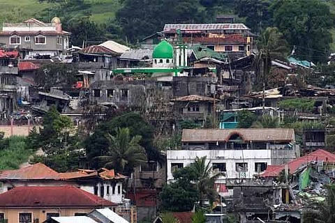 Damaged buildings and houses are seen as government forces continue their assault against insurgents