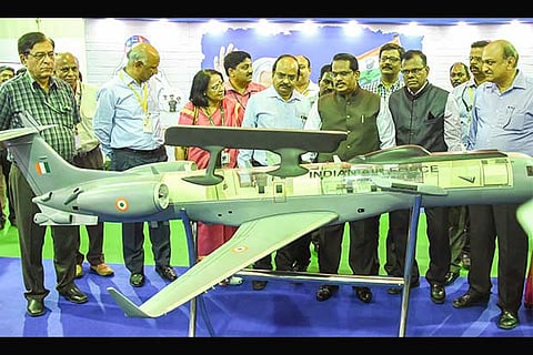 Visitors and officials looking at a model developed by DRDO at the exhibition held at CVRDE
