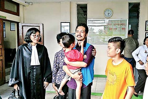 Fidelis Arie with his children at the court premises