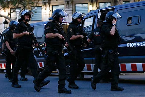 Spain hunts van driver who mowed down Barcelona crowd, killing 13