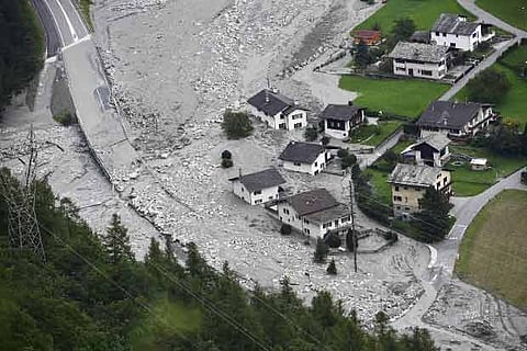 A rocky mudslide rushes towards the village in southern Switzerland after it was already hit by one