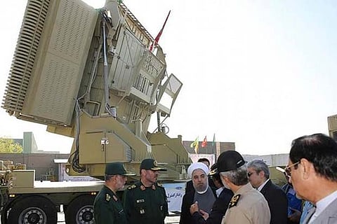 President Rouhani and Minister Hossein Dehghan stand in front of the new air defense missile system